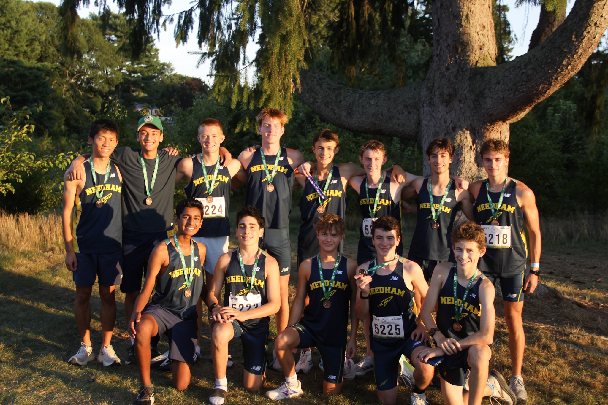 Needham boys celebrating after the MSTCA XC Relays